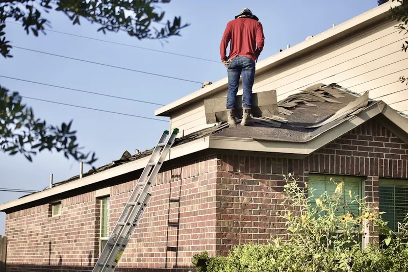 Professional roofer working on a residential roof in Tamarack